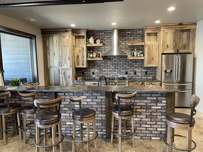 Thin-brick backsplash and island wainscot with hickory cabinets