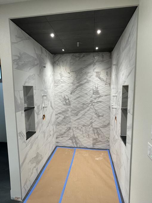 Book-matched marble shower with twin niches