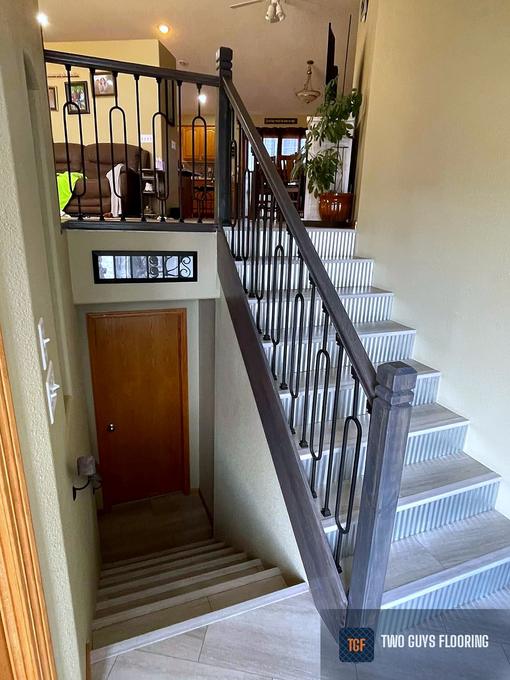 Tiled stair treads with fluted risers and an iron railing