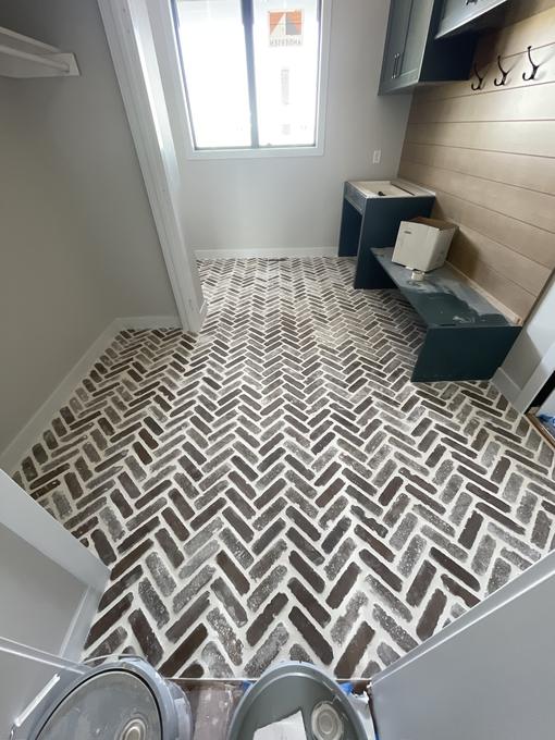 Herringbone mosaic mudroom floor